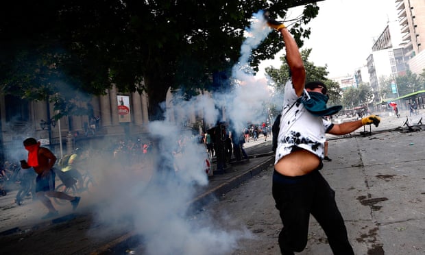 Demonstrators clash with police on the sixth day of protests against the Government, in Santiago, Chile, on Wednesday.