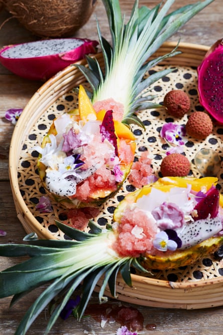 Watermelon ice served inside pineapple halves