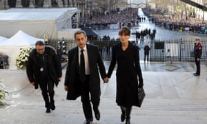 Former French president Nicolas Sarkozy arrives at the funeral ceremony with his wife Carla Bruni
