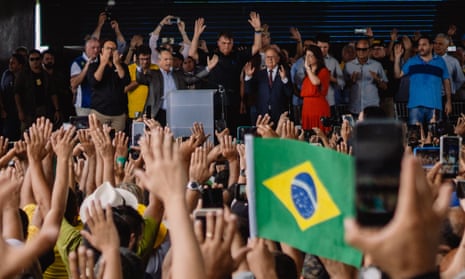Supporters raise their hands towards Jair Bolsonaro as evangelical pastors pray for him at a rally in Parnamirim, Brazil.