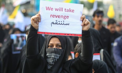 An Iraqi woman holds a placard during the funeral of Iranian military commander Qassem Suleimani, Iraqi paramilitary chief Abu Mahdi al-Muhandis and eight others in Baghdad on n 4 January.