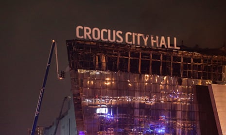 Russian firefighters extinguish a fire on the Crocus City Hall concert venue after a terrorist attack in Krasnogorsk