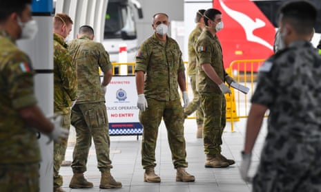 Australian Defence Force members wait for passengers to arrive for hotel quarantine at Sydney airport in August 2020