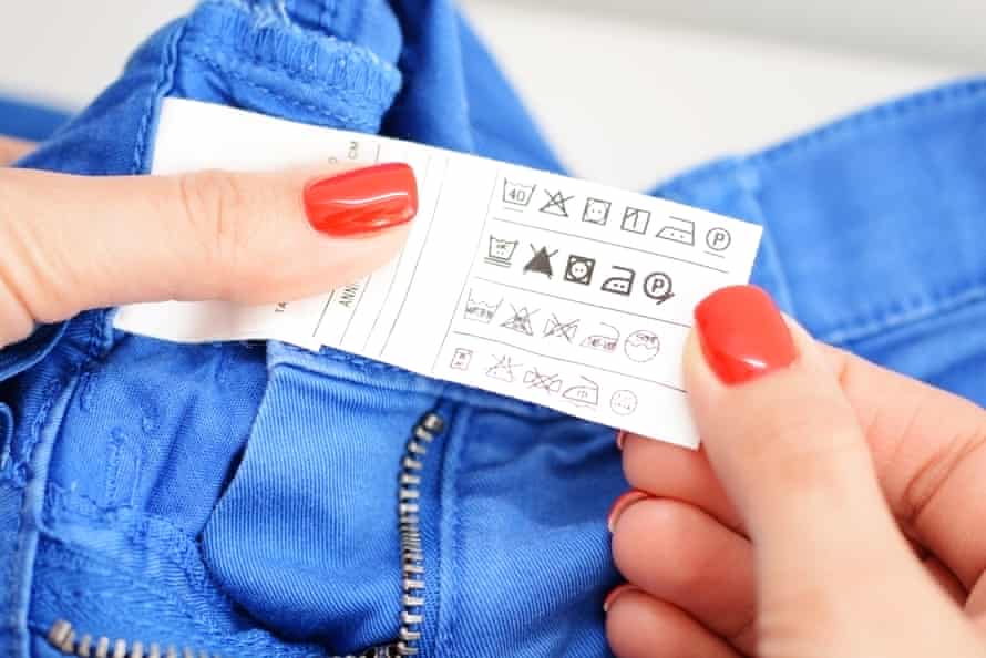 Woman examining washing instruction label