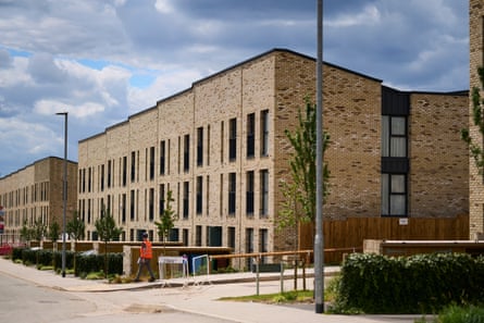 A row of three-storey beige-brick townhouses