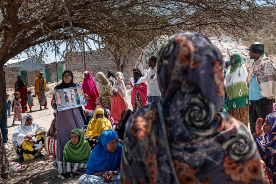 A woman teaches people in a camp in Borama about weapons safety and dangers from unexploded landmines.