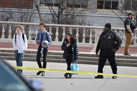 Denver teenager still at large after shooting two school officials, police say | denver 1 Students leave East High School in Denver, Colorado after a March 22 school shooting.