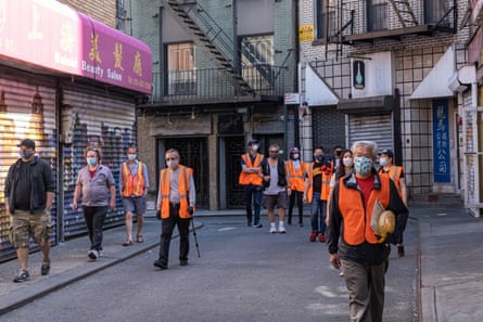 Karlin Chan, a volunteer for the Chinatown Block Watch, patrols the neighborhood in New York City on 17 May.