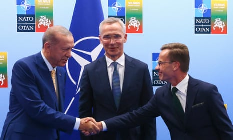 Turkey's president, Recep Tayyip Erdoğan, left, shakes hands with Sweden's prime minister, Ulf Kristersson, right, in Vilnius as Nato secretary general, Jens Stoltenberg, looks on.