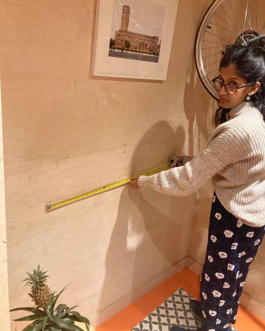 Priscilla Fernandes measuring her workspace, built during lockdown.