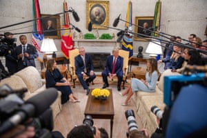 Journalists crowd the two heads of state during their press conference in the East Room of the White House.