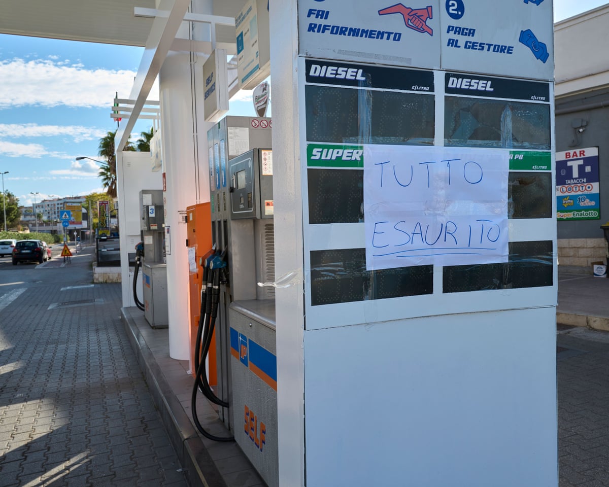 A handwritten "all sold out" sign covers a price board at a Puglia petrol station