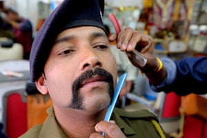A barber in Bhopal fulfills his customer’s request for a moustache in the style of the Indian air force pilot Abhinandan Varthaman, who was released from Pakistan after being shot down during a bombing raid near Kashmir. The unique moustache is in demand across the country