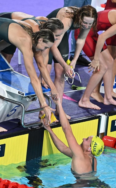 Ariarne Titmus is congratulated by teammates Madi Wilson, Kiah Melverton and Mollie O'Callaghan after her record-setting split in the women's 4x200m freestyle relay.