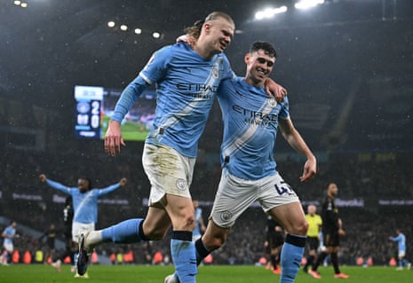 Erling Haaland (left) celebrates scoring Manchester City’s third goal with Phil Foden.