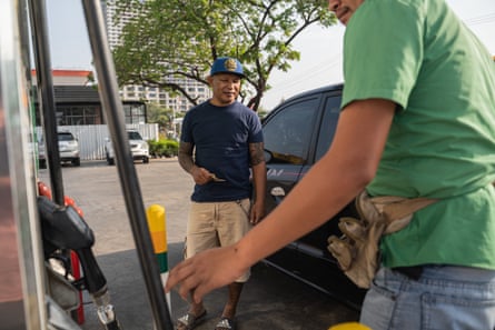 man filling up car with petrol
