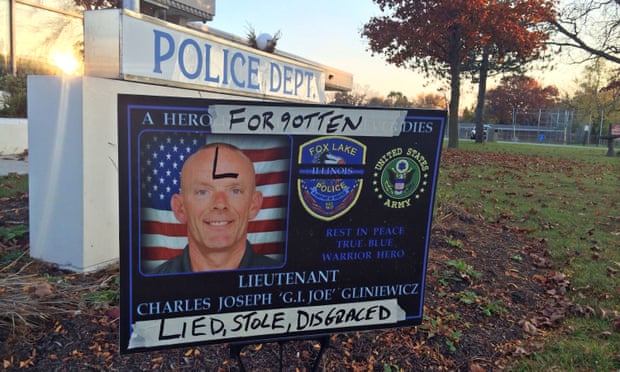 A sign honoring Fox Lake police lieutenant Charles Joseph Gliniewicz is defaced outside Fox Lake police department.