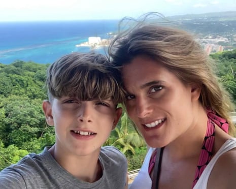 Ellen Roome and her son Jools Sweeney smile at the camera with a coastal landscape behind them