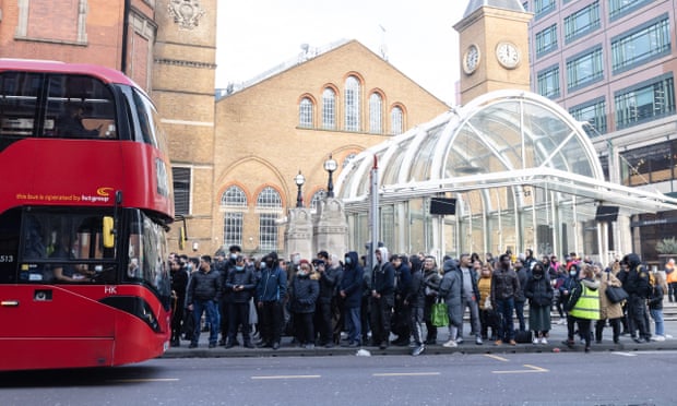 Commuters wait to get on a bus near Liverpool Street station