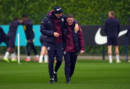 Thomas Tuchel and Anthony Barry (right) share a joke during a training session