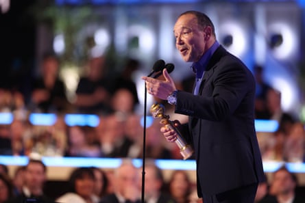 Stephen Graham accepts an award on stage