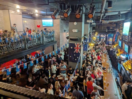 AFL fans watch the 2024 grand final at a party in New York.