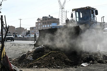 A bulldozer breaks down a barricade at a blockade zone in the city of El Alto on Saturday.