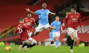 Manchester City’s Raheem Sterling reacts under pressure from Luke Shaw and Victor Lindelof of Manchester United.