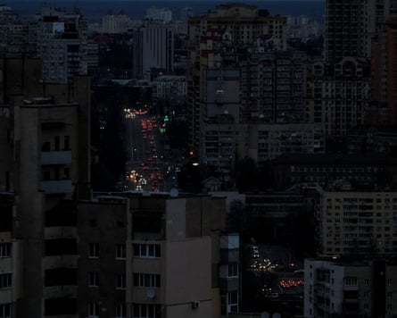 Traffic moves through the city centre during a blackout, in Kyiv.