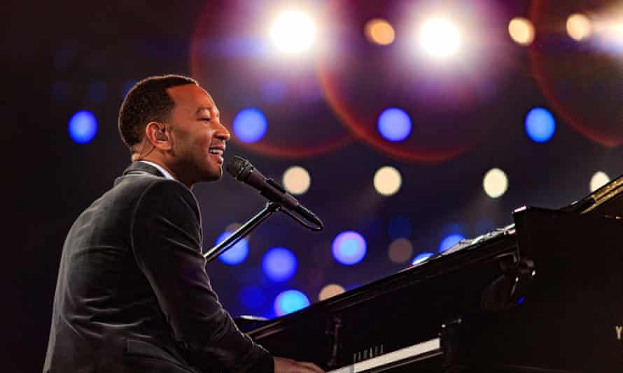A man plays the piano and sings during the performance.