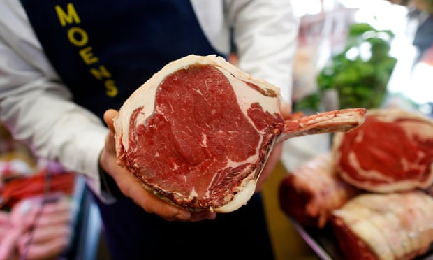 A butcher at M Moen &amp; Sons in Clapham, south London, holds a joint of British beef.