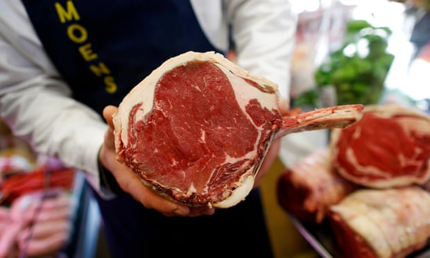 A butcher holds a joint of British beef