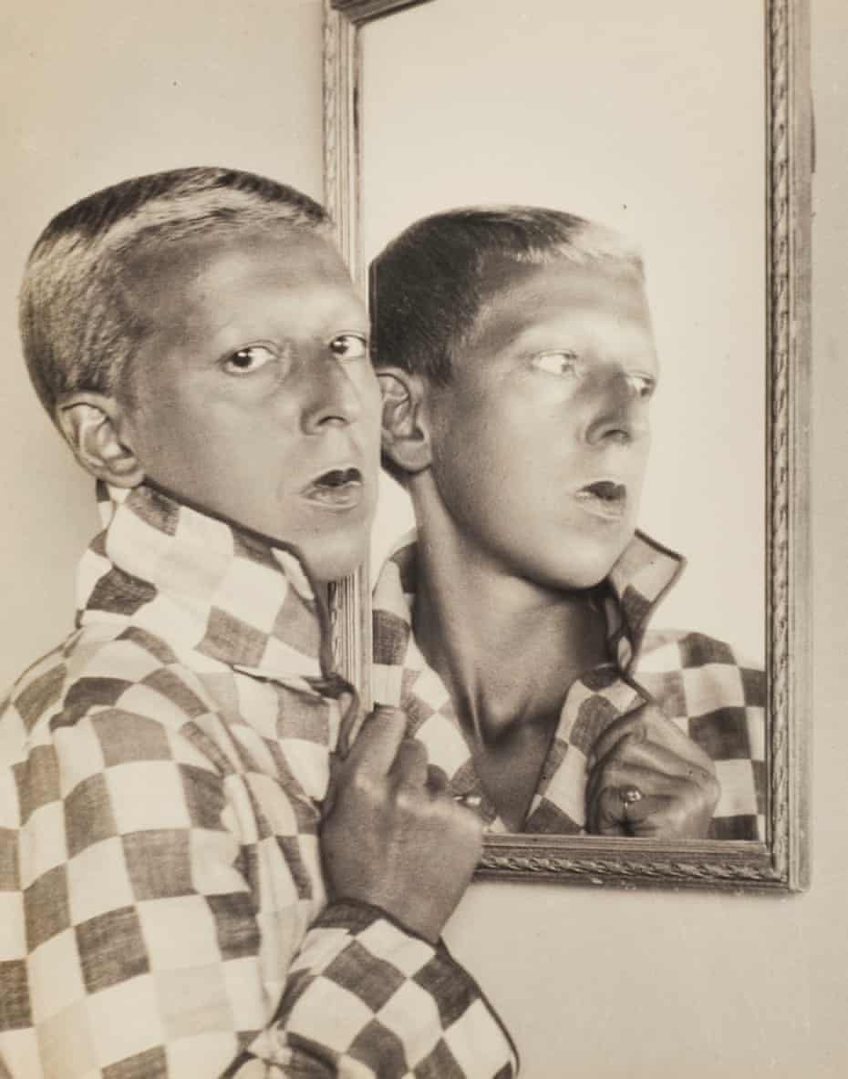 Self-portrait (reflected image in mirror with chequered jacket), 1927 by Claude Cahun.