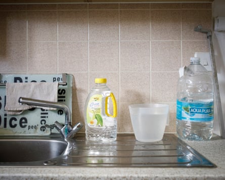 Plastic bottles containing water on a sink draining board