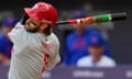 The Phillies' Bryce Harper (3) swings at a pitch with a decorated with the Phillie Phanatic during the first inning of Saturday’s game against the New York Mets in London.