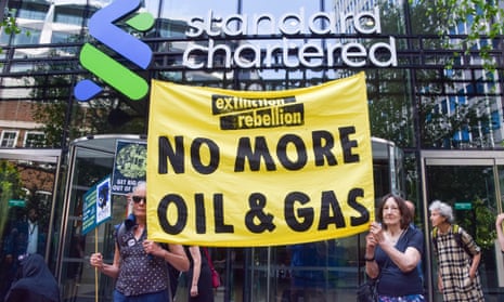 Extinction Rebellion COP 28 protest in London, UK - 12 Jun 2023<br>Mandatory Credit: Photo by Vuk Valcic/SOPA Images/Shutterstock (13962589o) Climate activists hold an anti-fossil fuels banner during the protest outside Standard Chartered offices. Extinction Rebellion staged a demonstration in the City of London, the capital's financial district, in protest against oil companies taking over COP 28, in support of climate justice, and in protest against fossil fuel financing. Extinction Rebellion COP 28 protest in London, UK - 12 Jun 2023