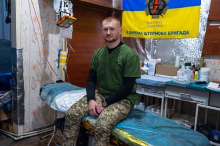 Ivan sits on a medical bed