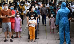 People observe social distancing while waiting to be tested at a makeshift rapid testing centre in Hanoi on 1 August.