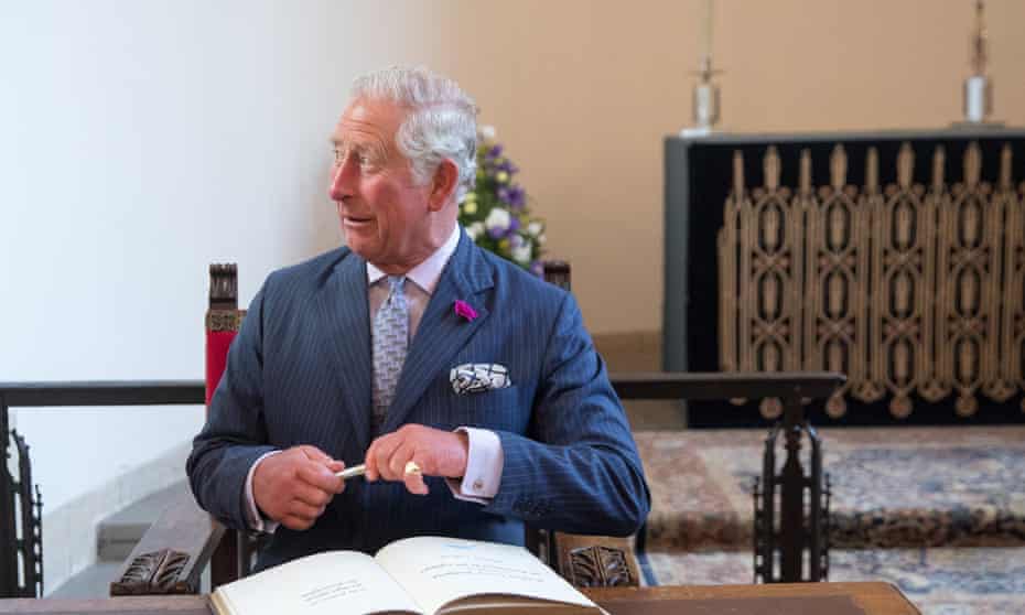 Prince Charles signs a visitors book at Llandaff Cathedral in Cardiff