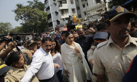 Bollywood actor Deepika Padukone, centre, arrives escorted by police to offer prayers at a Hindu temple ahead of the release of her upcoming film “Padmaavat” in Mumbai on Tuesday