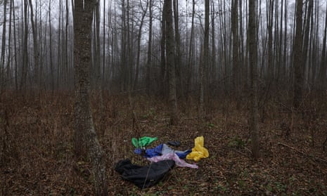 Sleeping bags and rain jackets lie in a forest in Poland nearby the border with Belarus.