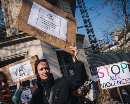 Women hold up placards in the street in Paris