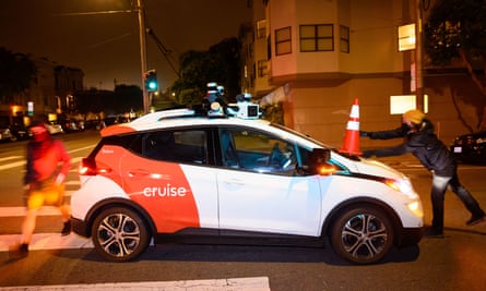 activists place a cone on a self-driving taxi in San Francisco