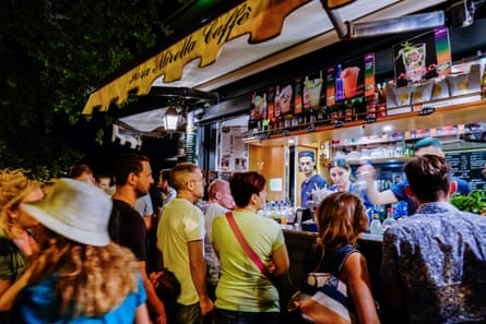 People queue to buy grattacheccha at night