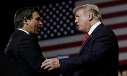 Donald Trump talks to Ron DeSantis during a rally in Tampa, Florida, in July 2018.