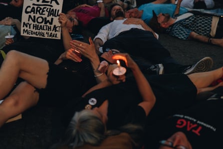 People lie together on a street.