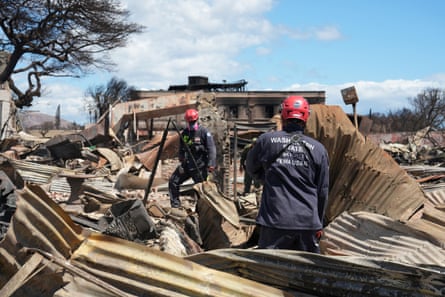 Members of a Fema search and rescue taskforce comb through destroyed neighborhoods in Lahaina.