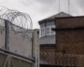 Walls and razor wire at a prison boundary