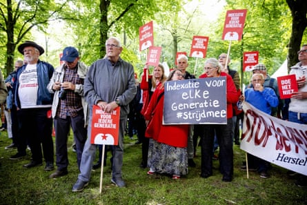 Protesters in The Hague hold placards at a demonstration against a new pension law