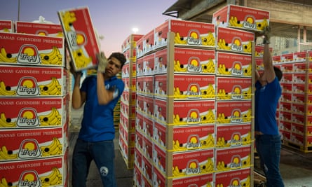 Workers stack bananas for shipping at Santa Marta port.